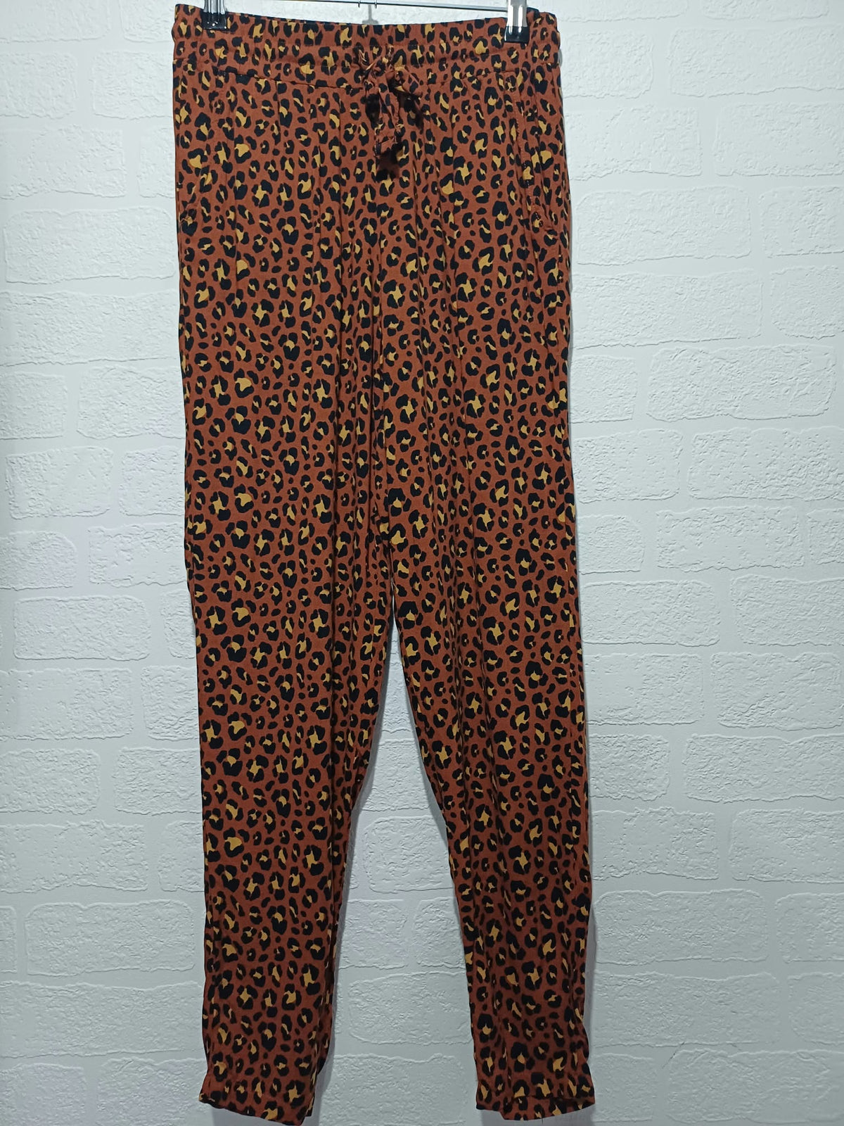 Women's Primark brown leopard print trousers full length on hanger